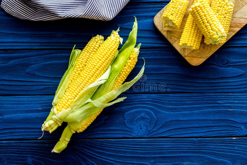 Cob corns on blue wooden background top view stock photography Cob corns on blue wooden background top view stock photography