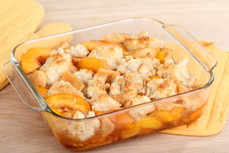 Peach cobbler dessert in a baking dish. Peach cobbler dessert in a baking dish