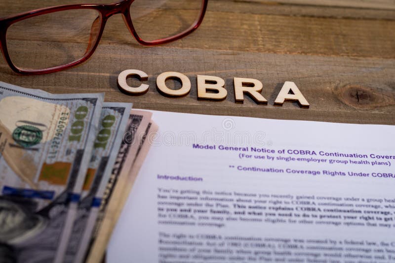 COBRA Healthcare Insurance Benefits for Unemployment concept.  COBRA letters and clipboard to review healthcare coverage.