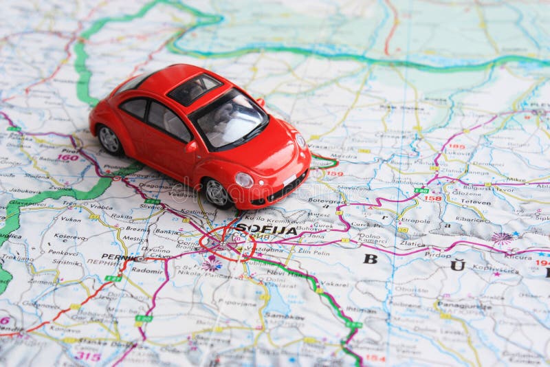 Miniature red car over Bulgaria road map. Miniature red car over Bulgaria road map