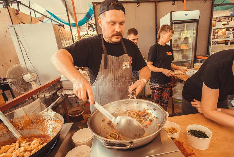 Cocine la preparación de la comida tailandesa con las especias y las verduras en un wok enorme fotos de archivo libres de regalías Cocine la preparación de la comida tailandesa con las especias y las verduras en un wok enorme fotos de archivo libres de regalías