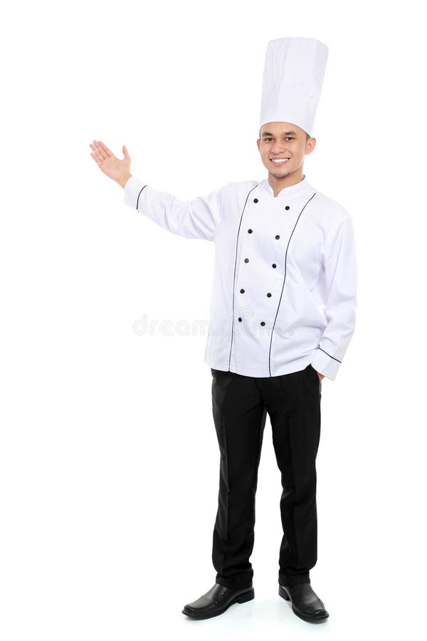 Cocinero de sexo masculino que sonríe presentando el espacio en blanco imagen de archivo libre de regalías Cocinero de sexo masculino que sonríe presentando el espacio en blanco imagen de archivo libre de regalías