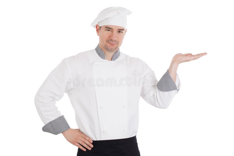 Cocinero joven que lleva a cabo algo a mano foto de archivo Cocinero joven que lleva a cabo algo a mano foto de archivo