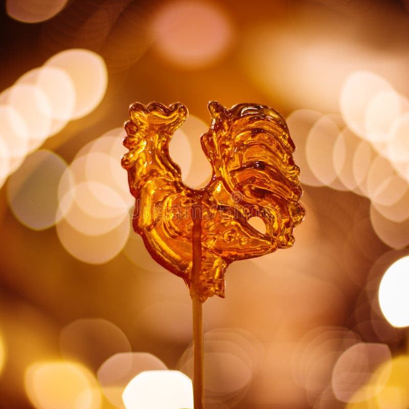 Cockerel Candy on a Stick. Hard Candy Rooster. Rooster Candy Symbol