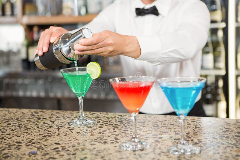 Barman affascinante che versa cocktail immagini stock libere da diritti