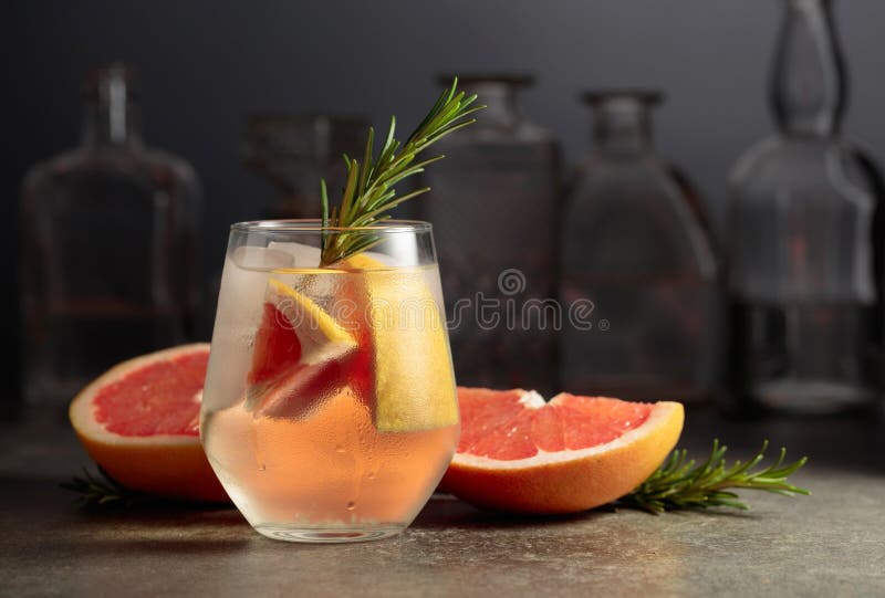 Cocktail Gin Tonic with Ice, Rosemary, and Grapefruit Stock Photo