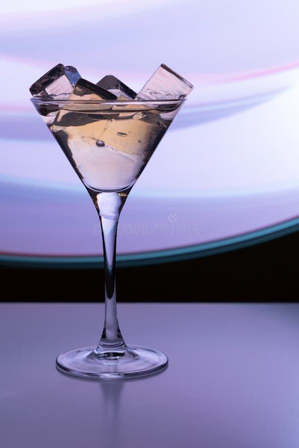 Cocktail glass with a drink and ice cubes royalty free stock photography Cocktail glass with a drink and ice cubes royalty free stock photography