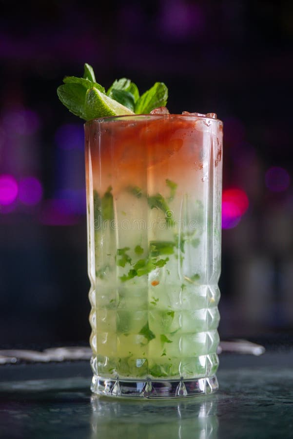 Cocktail with Lime and Herbs on a Marble Table of a Bar Stock Photo