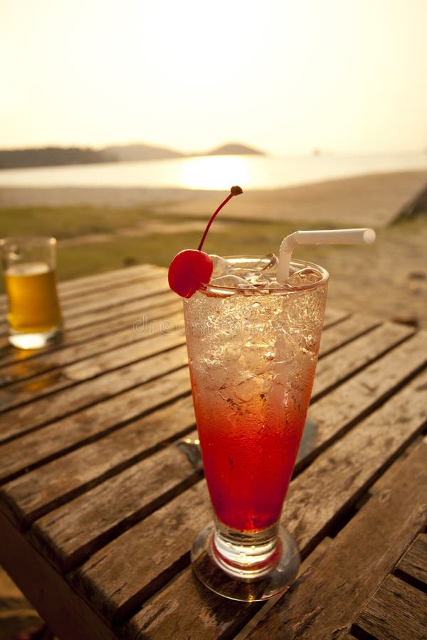 Cocktail and sunset stock image. Image of beach, straw - 30408225