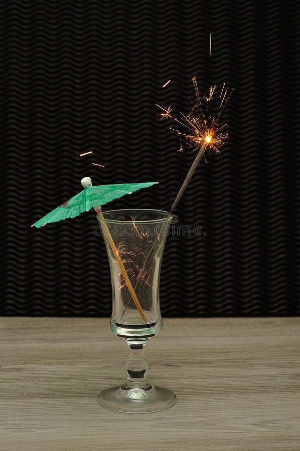 Cocktail Umbrella with a Sparkler in a Cocktail Glass Stock Photo
