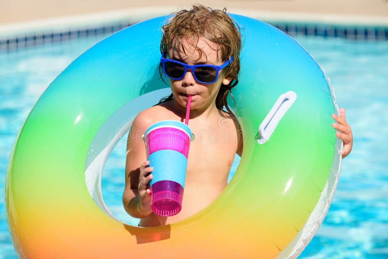 Cocktail on watter pool in the summer. Funny portrait of child. Kid having fun in swimming pool outdoors. Children with