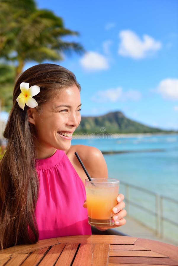 Cocktail woman drinking alcohol drink at beach bar