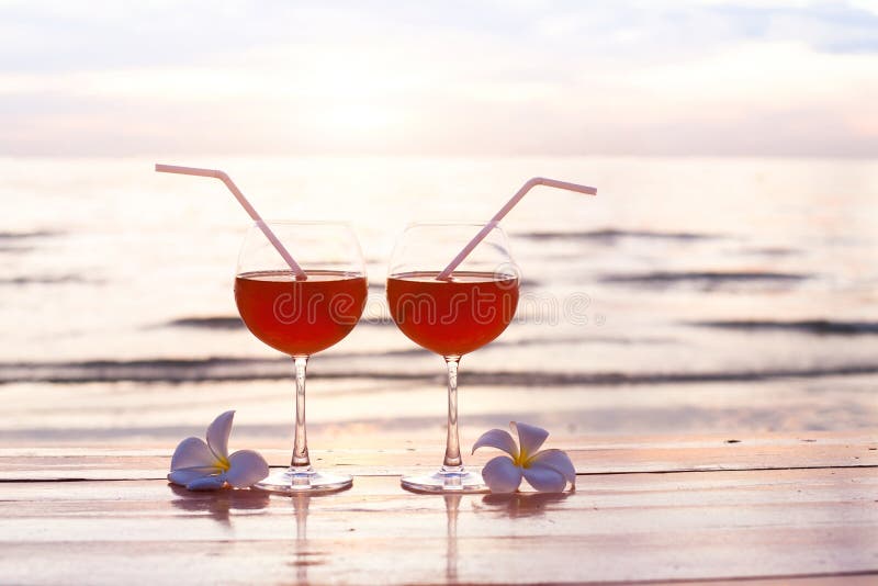 Cocktails on the beach at sunset, two glasses