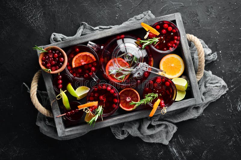 Cocktails and drinks with cranberries. Cranberries, limes, rosemary. On a black background. Top view. stock photo Cocktails and drinks with cranberries. Cranberries, limes, rosemary. On a black background. Top view. stock photo