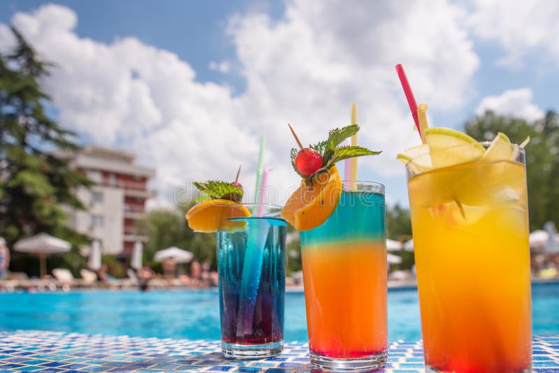 Cocktails by the pool stock photo. Image of holiday 168407874