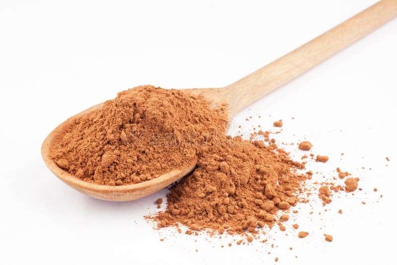Cocoa in a wooden spoon stock photography