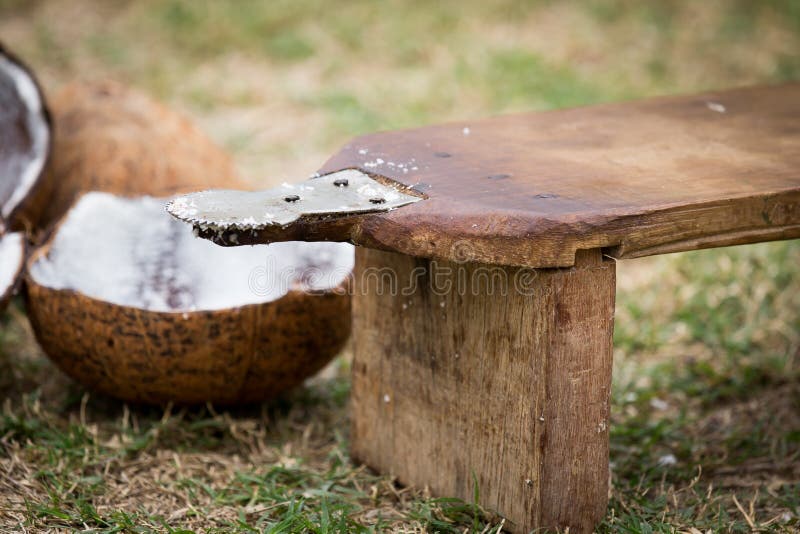 Close up of man hand grated coconut using an electric coconut grater in  Thailand Stock Photo