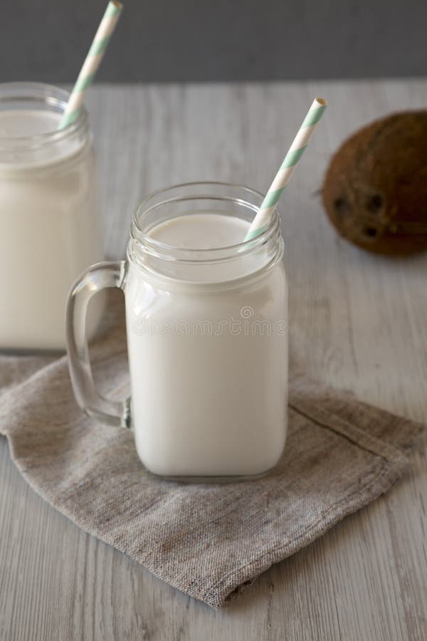 Coconut Milk in Glass Jars, Side View Stock Image Image of wood, gray