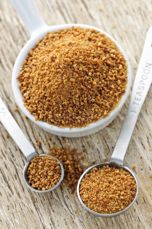 Coconut palm sugar in measuring spoons