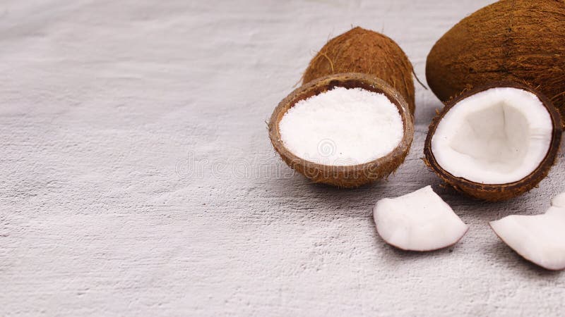Coconut and sliced coconut with powder coconut in shell appear on right side. Stop motion