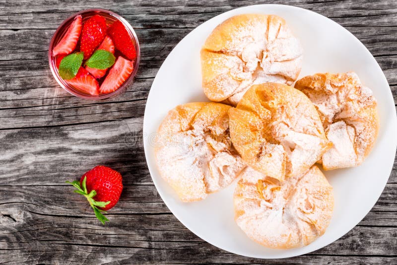 Coconut and strawberry puff pastries on a white dish