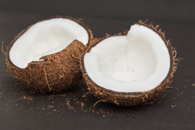 Coconuts Cut Open in Half Isolated on Black. Stock Photo - Image of ...