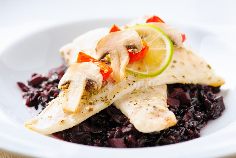 Cod filets over black rice stock image. Image of dish - 35544283