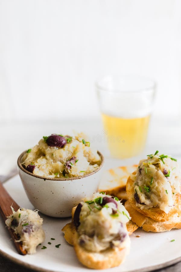 Cod Fish Brandade on a White Ceramic and Rustic Napkin Stock Photo