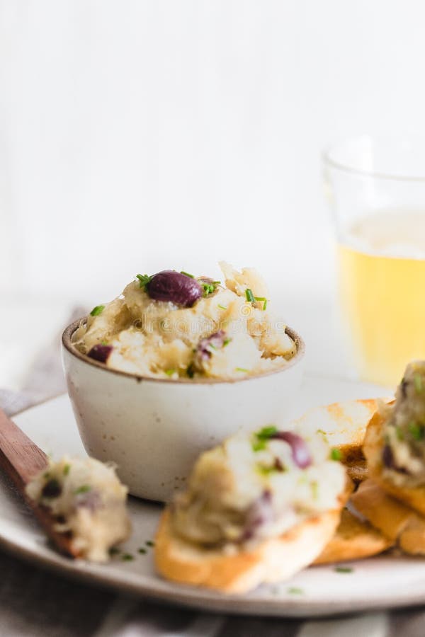 Cod Fish Brandade on a White Ceramic and Rustic Napkin Stock Photo