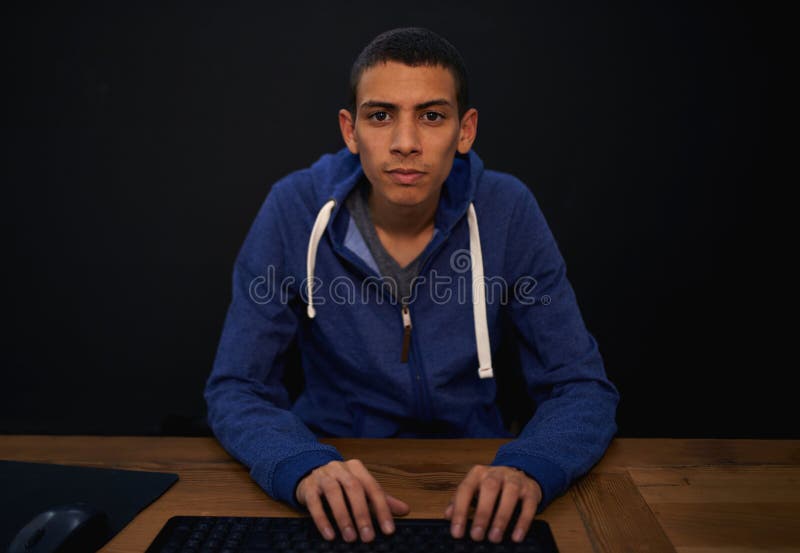 Coding, portrait and man typing on desk, working on assignment for gamer. Black background, programming and online royalty free stock photos