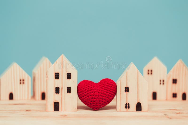 Love heart between two house wood model for stay at home for healthy community together concept. Love heart between two house wood model for stay at home for healthy community together concept.