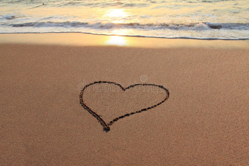 Heart in the sand on the beach at sunset. Heart in the sand on the beach at sunset.