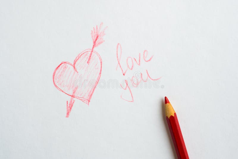 Coeur dessin? sur le papier, l'amour d'inscription vous et un crayon rouge sur le livre blanc images libres de droits Coeur dessin? sur le papier, l'amour d'inscription vous et un crayon rouge sur le livre blanc images libres de droits