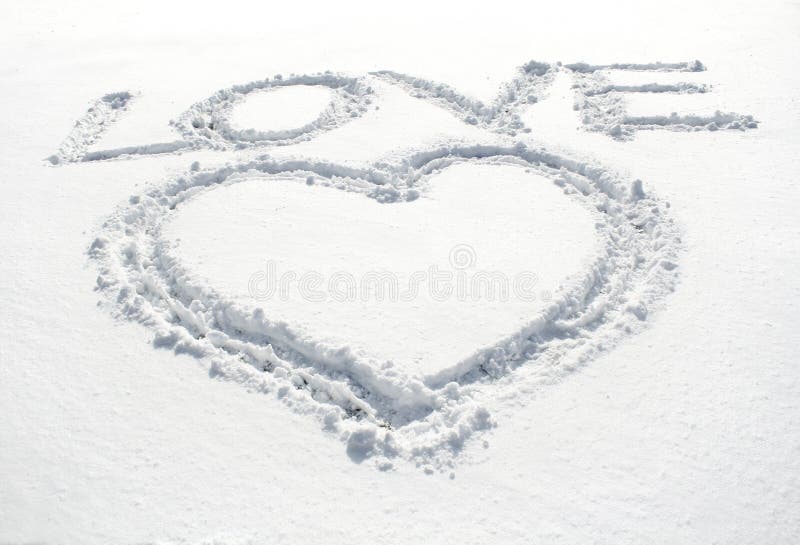 Heart and inscription love written on glittering snow. Heart and inscription love written on glittering snow