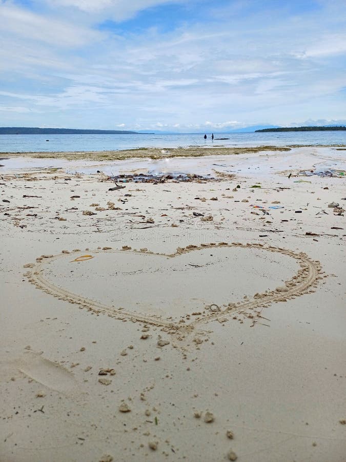 Heart on white sand at the beach of Banggai Kepulauan, Central Sulawesi, Indonesia. Love symbol or travel destination. Heart on white sand at the beach of Banggai Kepulauan, Central Sulawesi, Indonesia. Love symbol or travel destination