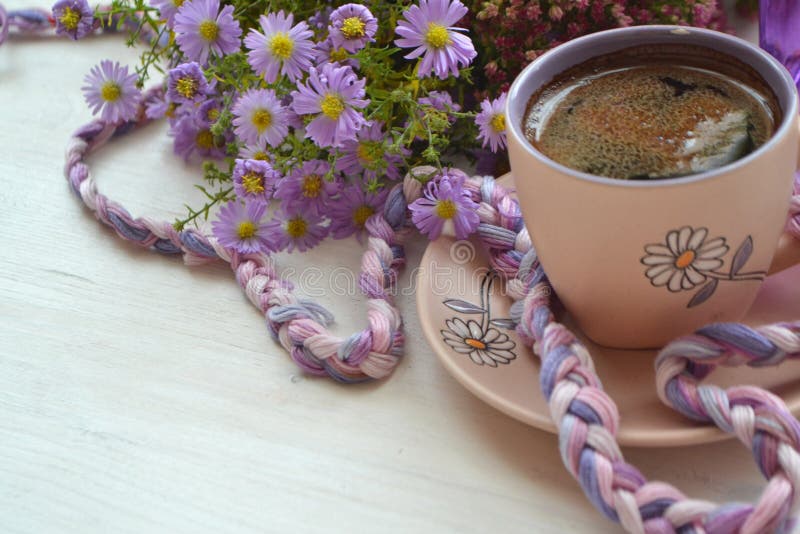 Violet cup of morning coffee or cappuccino and delicate purple, lilac  flowers. Mother's day concept. Cozy breakfast Stock Photo - Alamy