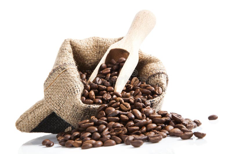 Coffee beans in bag with wooden spoon.