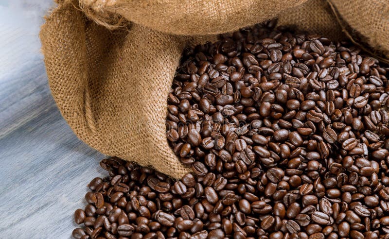 Coffee beans in a bag on wooden table