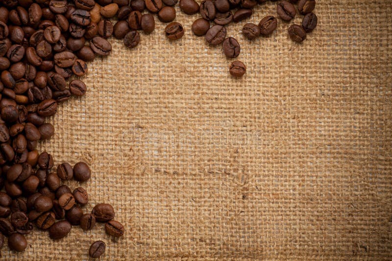 Coffee beans on burlap background