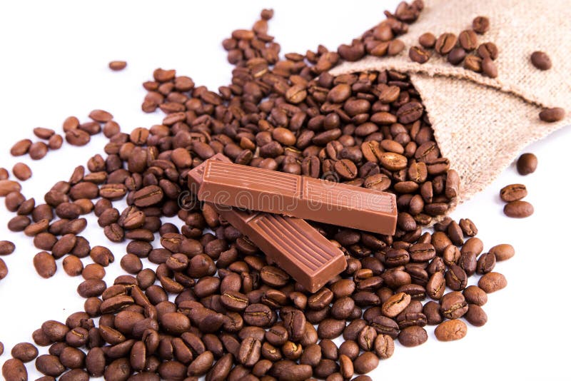 Two Coffee Beans Broken into Powder Closeup on a White Stock Image