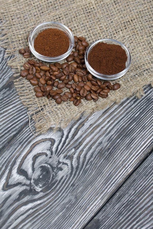 Coffee Beans on Coarse Linen. Ground Coffee in Containers Stock Photo
