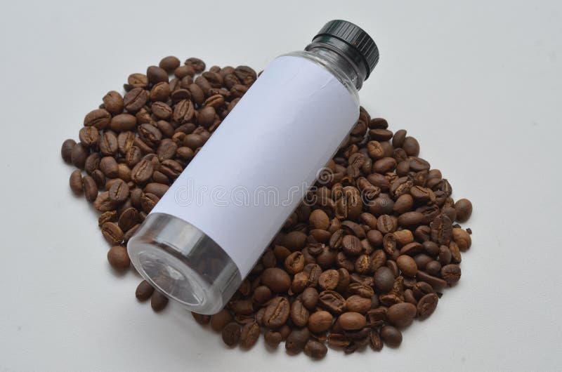 Coffee Beans and Empty Bottle Isolated at White Background Stock Image