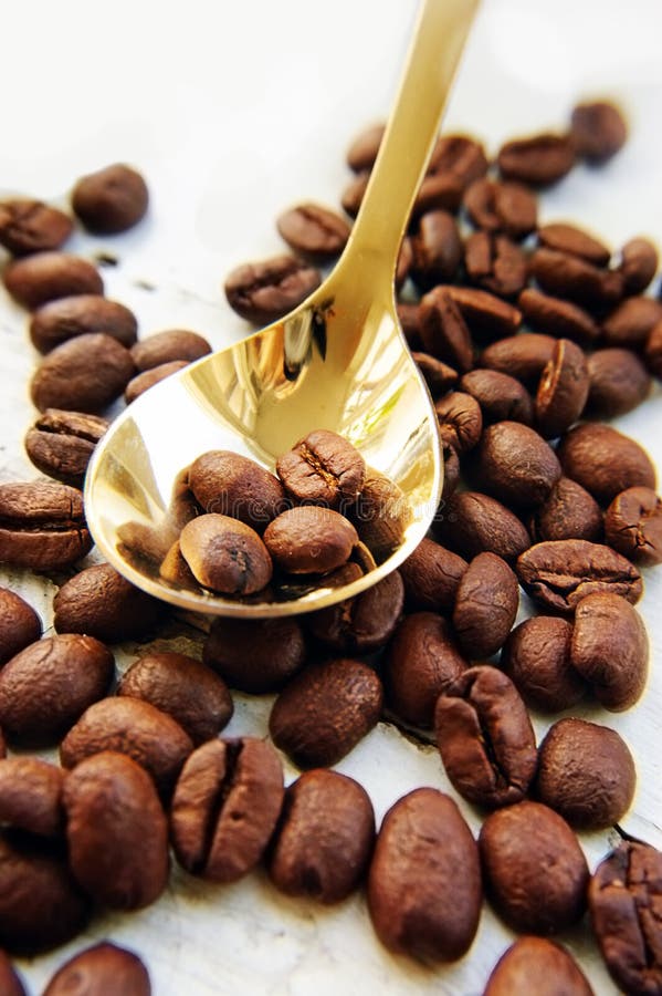 Coffee beans and golden spoon