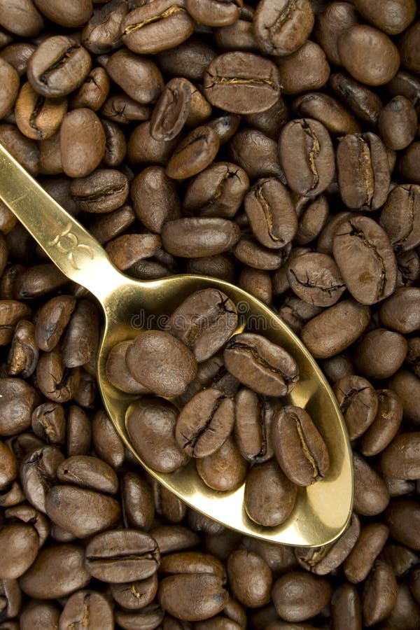 Coffee beans and golden spoon