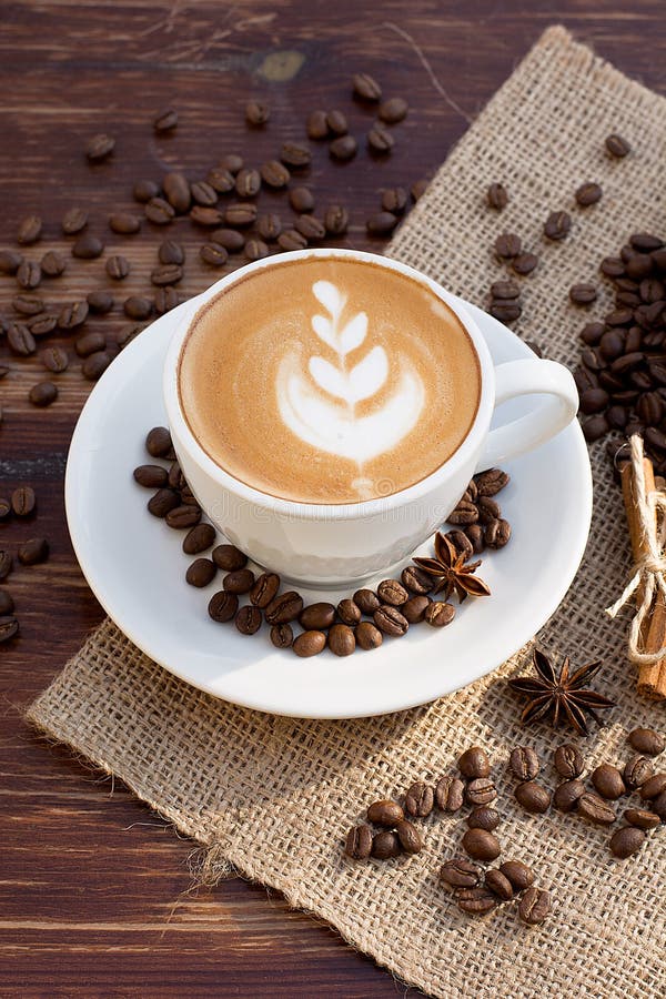 A Cup of Latte Coffee and Coffee Beans. Stock Photo - Image of foam ...