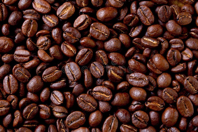 Few Quality Roasted Coffee Beans at Dark Marble Sufface. High Quality