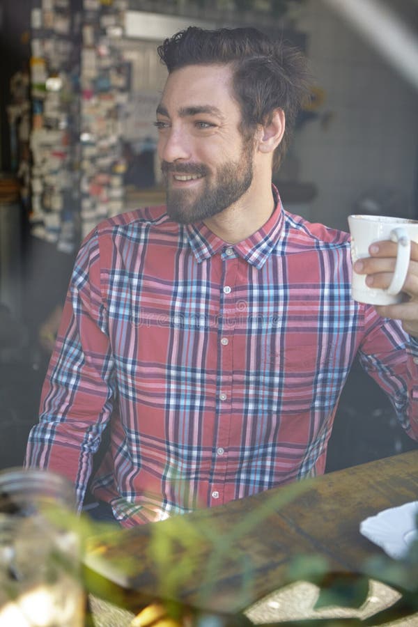Coffee is Better Than No Coffee. a Young Man Drinking Coffee in a Cafe