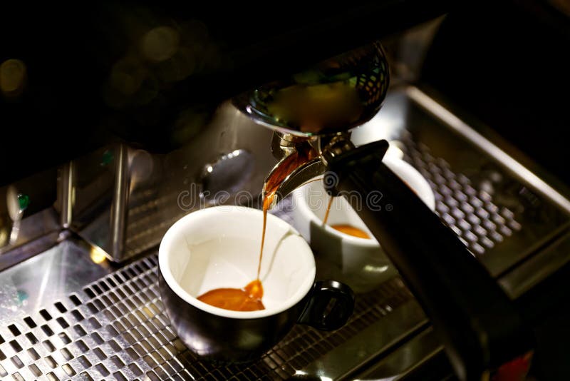 Coffee Brewing in Coffee Machine. Espresso Pouring in Two Cups Stock