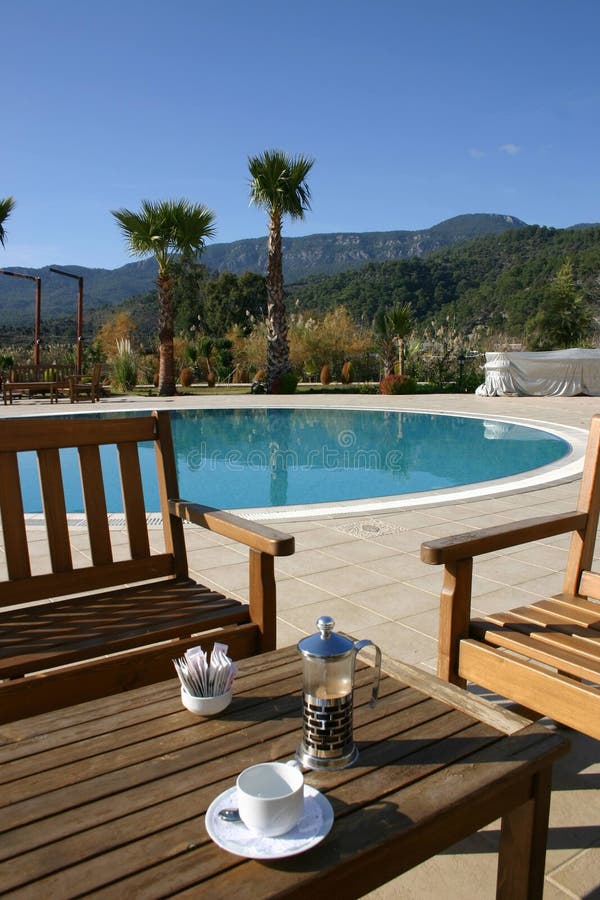 Coffee bye the pool stock image. Image of pool, table 268146781