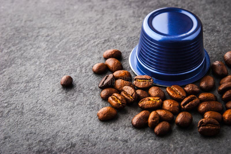 Coffee Capsule and Coffee Beans on the Dark Table Horizontal Stock